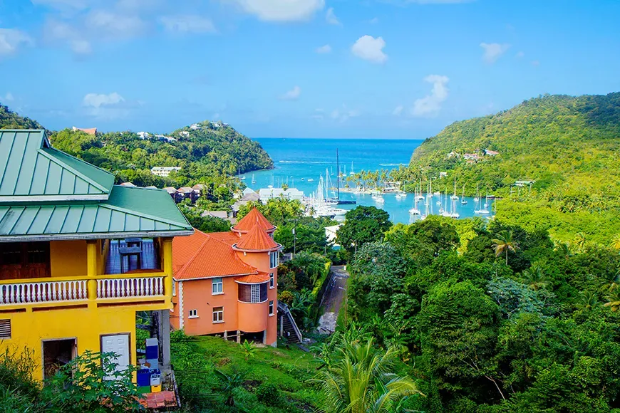 st lucia colorful houses and harbor with boats.